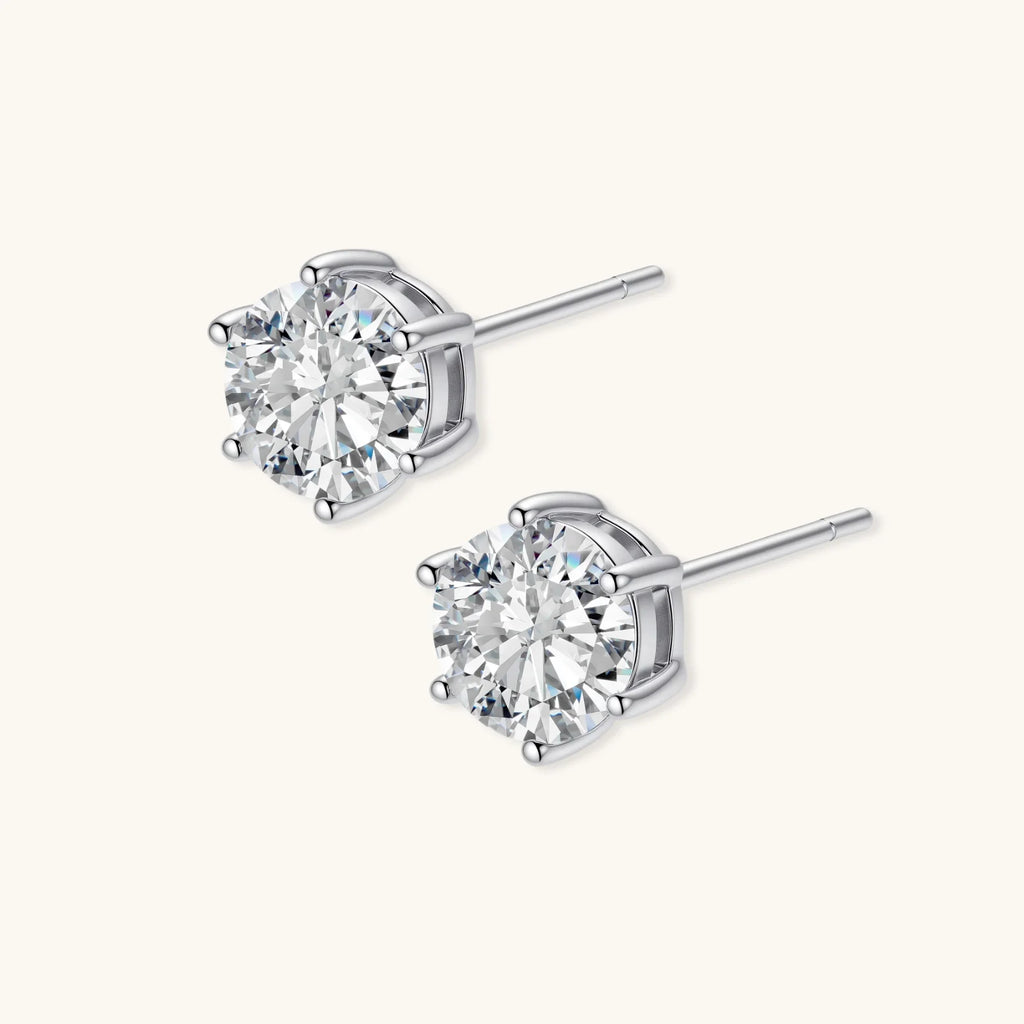 Close-up of round brilliant-cut moissanite stud earrings in 6-prong sterling silver settings showing exceptional sparkle