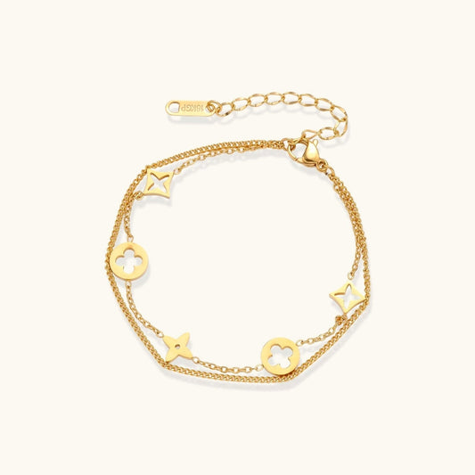 Havora Lucky Star charm bracelet featuring double gold-toned chains with quatrefoil and star motifs on a wrist.