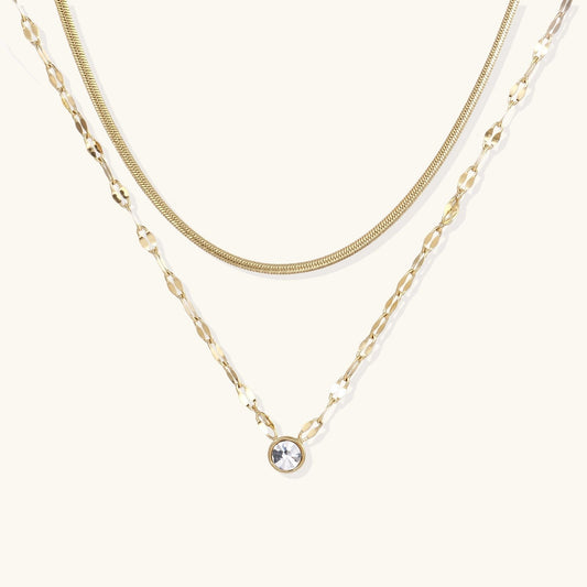 Havora Golden Hour Layers necklace featuring a gold snake chain and a flat-link chain with a single bezel crystal.
