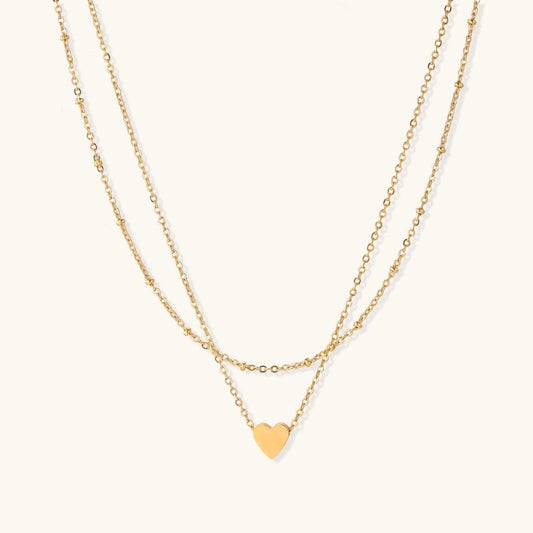 Havora layered necklace featuring a delicate beaded chain and a smooth cable chain with a polished gold heart pendant.